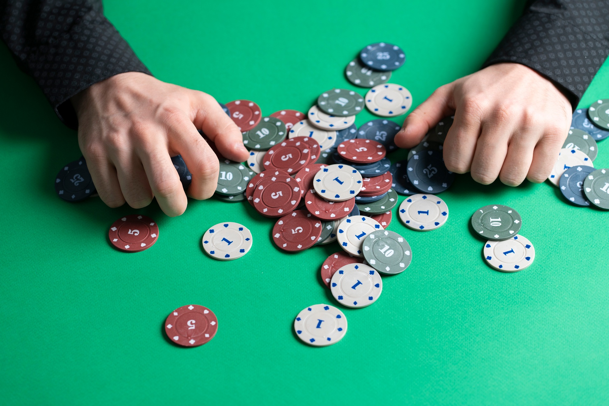 a person grab casino playing chips as the symbol of winning of jackpot